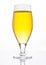 Glass of beer cider with foam golden color white