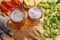 Glass beer with crawfish, dried fish and hop cones on light wooden background. Beer brewery concept. Beer background. top view