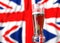 a glass of beer in front a united kingdom flag. 3D illustration rendering.