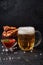 Glass of beer, grilled chicken wings and tomato sauce