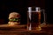 A glass of beer and a hamburger. Wooden dark background. Snack, food for beer