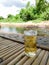 Glass of beer with ice on bamboo table