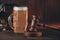 Glass of beer and judge gavel as a symbol of law on a wooden table