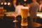 Glass of beer placed casting a shadow on the sky bar counter in restaurant. Cold beer, perfect for hang out after work.