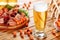 Glass of beer on wooden table background. Jamon and coated crunchy peanuts, great snack. Side view