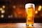 Glass of beer on wooden table. Blurred background with space for text, copyspace, banner