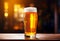 Glass of beer on wooden table. Blurred background with space for text, copyspace, banner