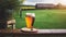 Glass of beer on wooden table, English countryside pub