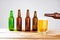 Glass of beer on wooden table, top view. Beer bottles. Selective focus. Mock up. Copy space.Template. Blank.