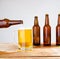 Glass of beer on wooden table, top view. Beer bottles. Selective focus. Mock up. Copy space.Template. Blank.