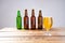 Glass of beer on wooden table, top view. Beer bottles. Selective focus. Mock up. Copy space.Template. Blank.