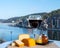 Glass of Belgian abbey beer and tasting of cheeses made with trappist beer and fine herbs with view on Maas river in Dinant,