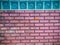 Glass blocks on the red brick wall background. Square glass bloc