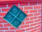 Glass blocks on the red brick wall background. Square glass bloc