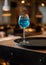 Glass of blue lagoon cocktail on bar counter