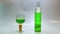 Glass bottle and authentic cup with green liqueur drink