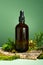 Glass bottle of body oil. A conceptual composition of essential oil, moss and tree bark on a green background. Oil serum for skin
