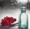 glass bottle close-up red berries bokeh background