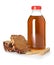 Glass bottle of delicious kvass, spikelets and bread slices on white background. Refreshing drink