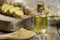 Glass bottle of essential ginger oil, ginger root and powder on wooden rustic background