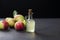 Glass bottle of handmade organic apple cider vinegar made from fermented fresh ripe apples