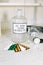 Glass bottle with latin label of isotonic solution, blister packs of different tablets, scales, glass flask and