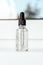 Glass bottle with liquid with bubbles. Front view