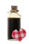 A glass bottle of love potion in brown with a red gingham heart