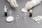 Glass Bottle with medicines. Hands in medical gloves hold a syringe