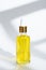Glass bottle with pipette with cosmetic yellow oil on white background