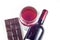 A glass, a bottle of red wine, a bar of chocolate on a white background.