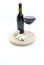 Glass and bottle with red wine and molded cheese aside wine tasting luxury concept