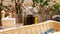 Glass bottle with sauce and butter for pizza and pasta, standing on a served wooden table in an Italian restaurant with brick