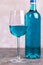 Glass and bottle of trendy blue wine. Spanish blue wine