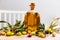 Glass bottles and carafes with fresh olive oil on wooden table with olive branches and fresh olives