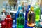 Glass bottles with colorful alcoholic products. Making alcoholic drinks at home. Close-up