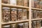 Glass bottles with colorful spices on the shelfs