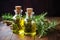 glass bottles with essential oils, rosemary twigs on table