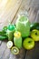 Glass bottles with green smoothies made with green fruits. Detox and healthy diet background