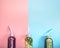 Glass bottles with natural drinks on a colored background