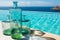 Glass bottles next to an infinity pool