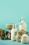 Glass bottles of vegan plant milk and almonds, nuts, coconut, hemp seed milk on blue background. Banner with copy space. Dairy