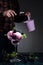 Glass bowl with blackberry ice cream and berries on a dark background