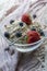 Glass bowl with cereals, strawberries and blueberries