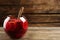 Glass bowl of delicious aromatic punch drink and ladle on wooden table. Space for text