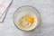 Glass bowl with dough on a gray background. Cooking greek easter orange sesame koulourakia cookies step by step