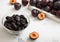 Glass bowl with dried sweet prunes with ripe plums in wooden box.Macro