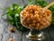 Glass bowl filled with boiled chickpeas with wooden spoon