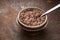 Glass bowl with flax seeds in the water on the metal background horizontal