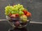 glass bowl of fresh washed fruit - apples bunch of grapes strawberry and nectarine